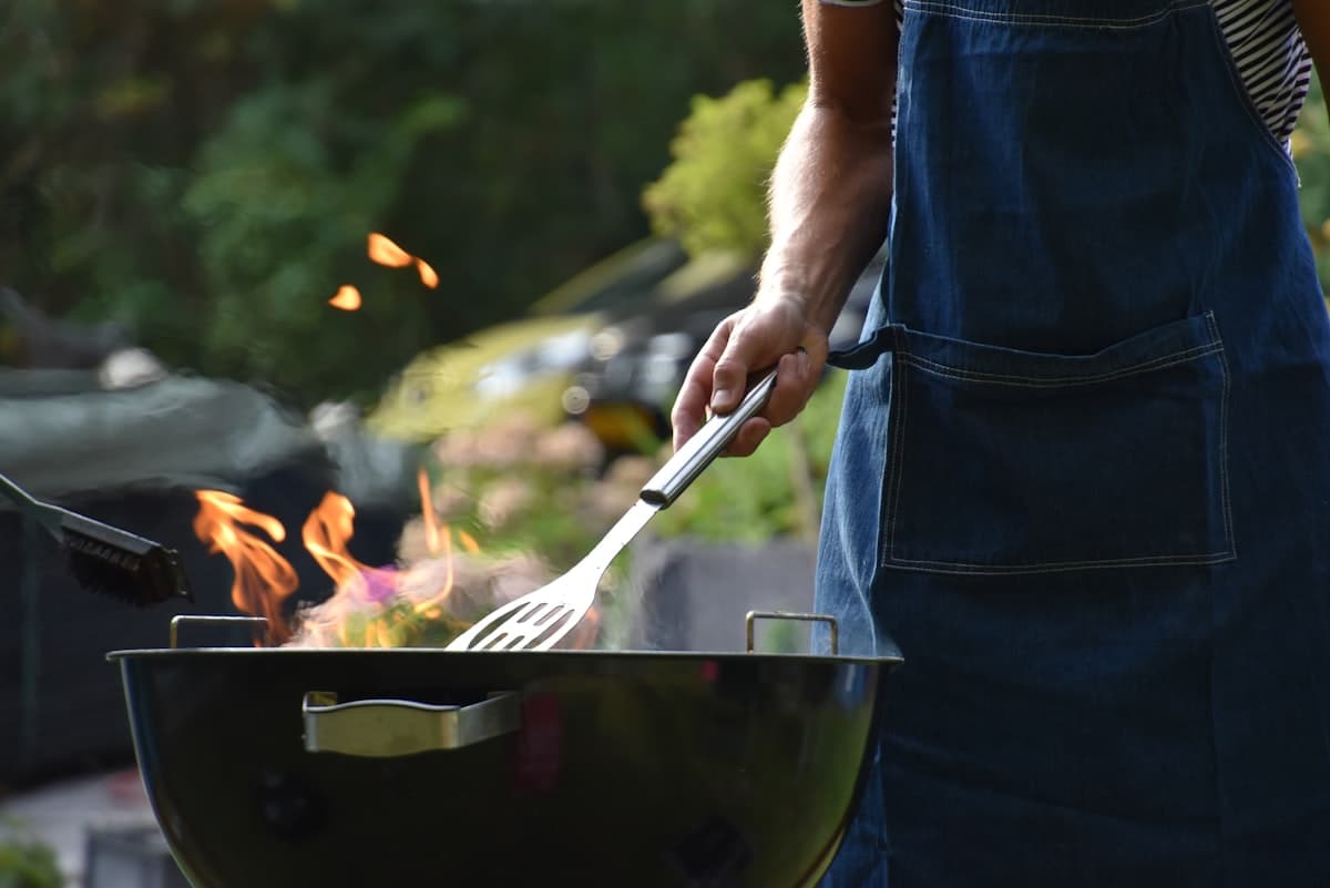 Grilling over an open flame at dusk